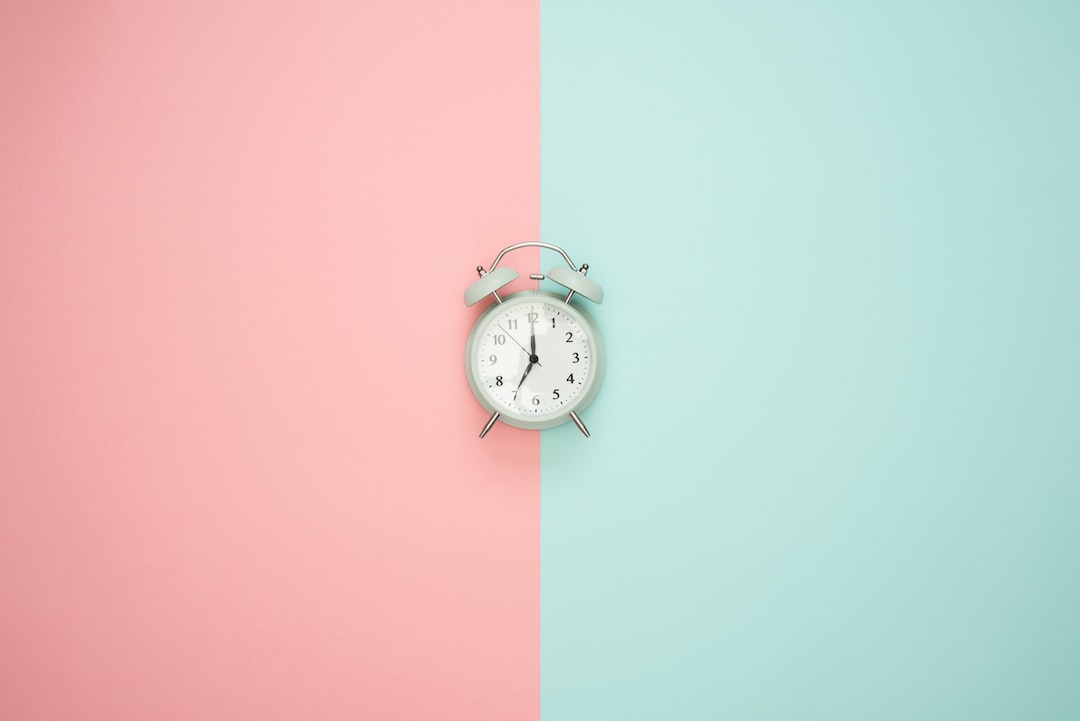 Blue clock on a pastel background