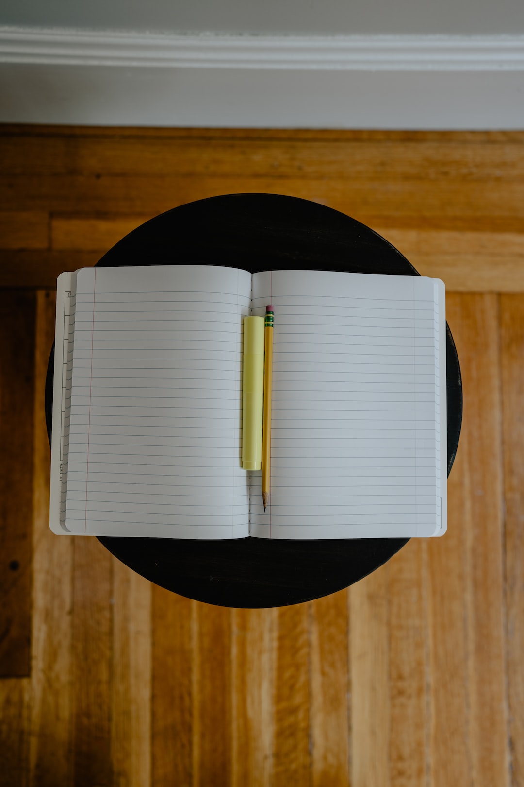 pencil and highlighter on an open notebook