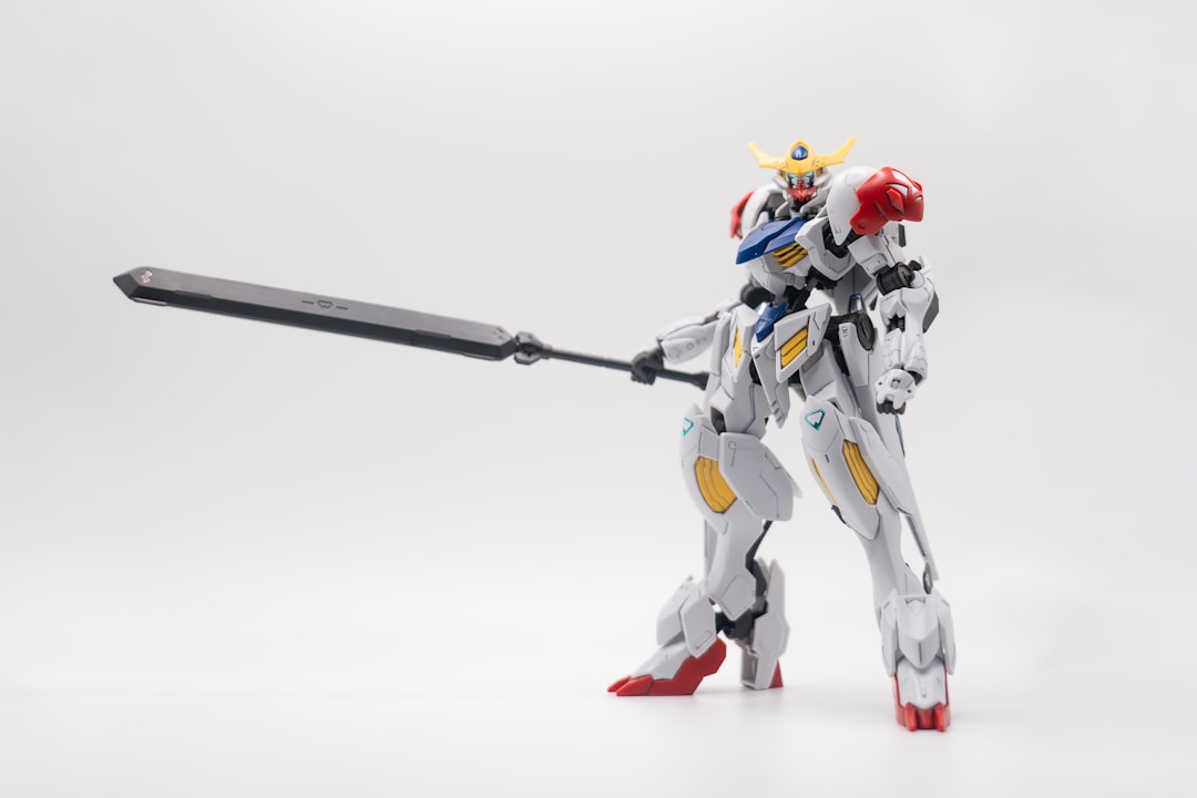 a robot that is holding a sword on a white background