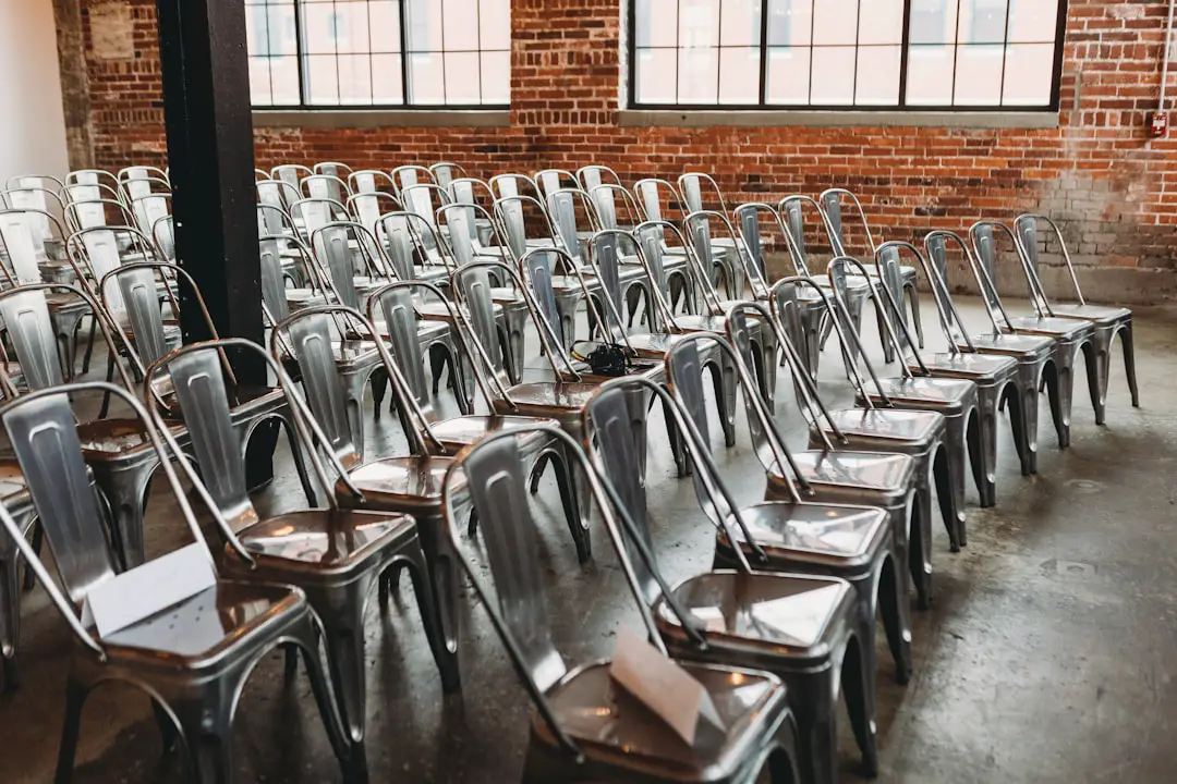 a room filled with lots of metal chairs